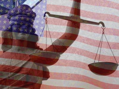 Lady Justice holding scales with an American Flag